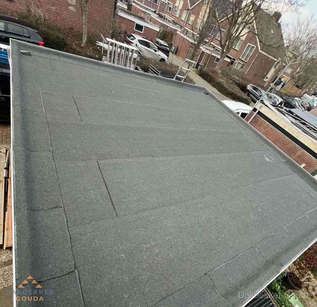 Nieuwe bitumen dakbedekking op plat dak van garage in Gouda