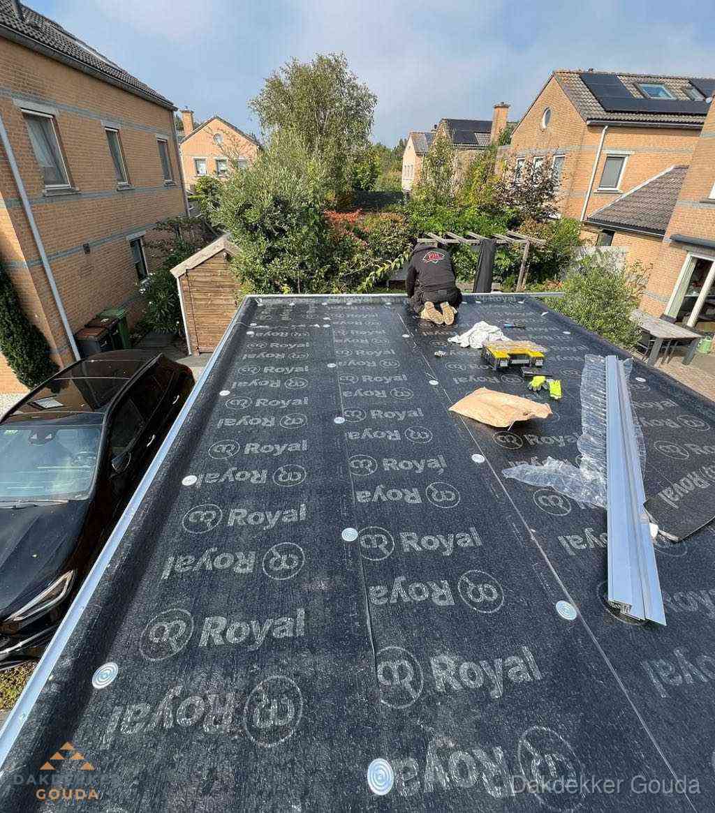 Dakdekker aan het werk op plat dak renovatie in Gouda